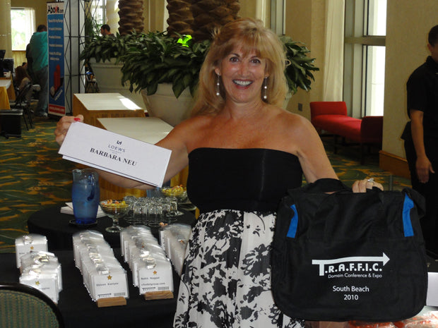 Barbara Dillman-Neu holding her name card at the T.R.A.F.F.I.C. conference registration desk